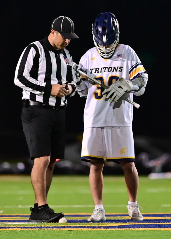lacrosse ref standing with lacrosse player